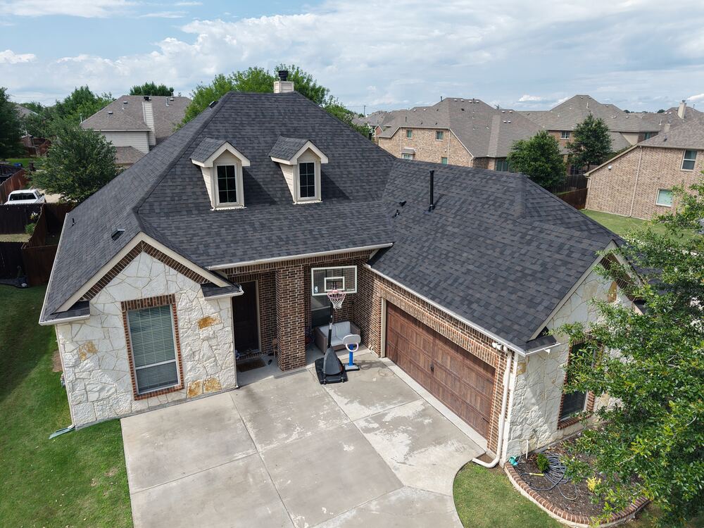 Completed dark gray shingle roof, aerial drone view