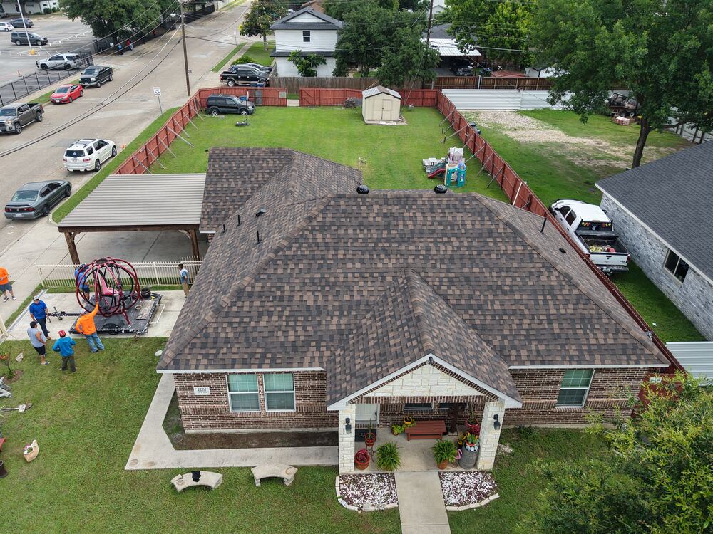 Completed multi-gable roof with backyard, aerial drone view