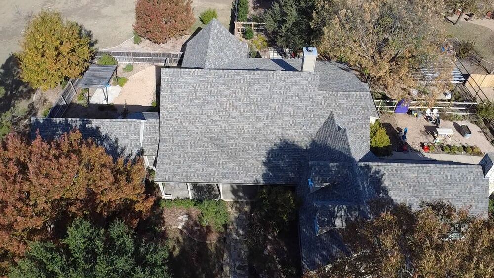 Completed light gray shingle roof, aerial drone view