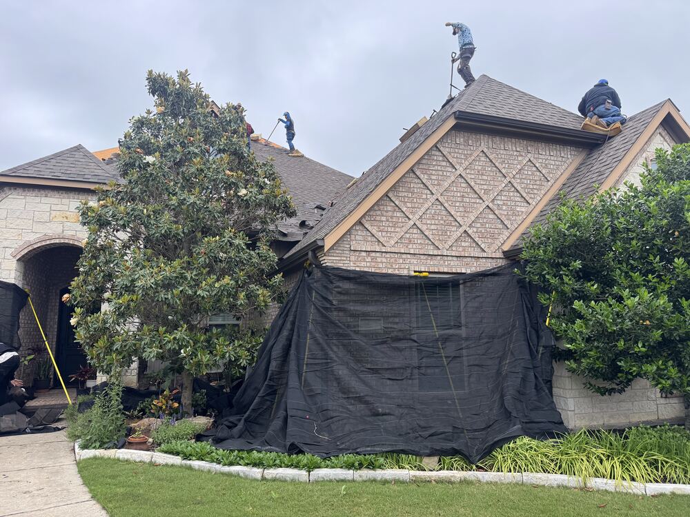 Job site prepped with protective tarps before roof tear-off